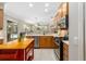 Modern kitchen with stainless steel appliances, a functional island, and an open layout to the living area at 7804 Edmonston Cir, University Park, FL 34201