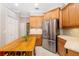 Kitchen features a large island with wine storage and stainless steel refrigerator at 7804 Edmonston Cir, University Park, FL 34201