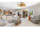Open floor plan with a spacious living room that opens to an outdoor pool area at 7804 Edmonston Cir, University Park, FL 34201