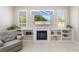 Bright living room features a fireplace, built-in shelving, and coastal themed decor at 7804 Edmonston Cir, University Park, FL 34201