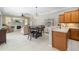 Inviting living space with a kitchen island, dining area, and comfortable seating area, creating a warm atmosphere at 7804 Edmonston Cir, University Park, FL 34201
