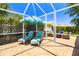 Screened in patio with lounge chairs and umbrella at 7804 Edmonston Cir, University Park, FL 34201