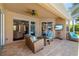 Relaxing outdoor patio featuring comfortable wicker furniture, a ceiling fan, and a picturesque view of the pool at 7804 Edmonston Cir, University Park, FL 34201