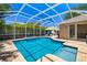 Sparkling screened-in pool and jacuzzi area, perfect for relaxing and enjoying the outdoors at 7804 Edmonston Cir, University Park, FL 34201