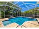 Stunning screened-in pool with a jacuzzi, surrounded by lush landscaping and sunny skies at 7804 Edmonston Cir, University Park, FL 34201