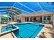 Stunning screened-in pool and spa area, surrounded by a spacious patio and lush landscaping at 7804 Edmonston Cir, University Park, FL 34201
