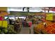 Interior shot of Detwiler's market showcases various produce sections with customers shopping, surrounded by displays at 7804 Edmonston Cir, University Park, FL 34201