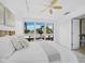 Brightly lit bedroom featuring a ceiling fan, windows and a comfortable bed at 800 S Blvd Of The Presidents # 19, Sarasota, FL 34236