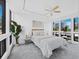 Brightly lit bedroom featuring a ceiling fan, windows and a plant at 800 S Blvd Of The Presidents # 19, Sarasota, FL 34236