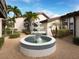 Well-manicured courtyard with a tiered fountain and a tropical landscape at 800 S Blvd Of The Presidents # 19, Sarasota, FL 34236