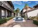 Well-manicured courtyard with a tiered fountain and tropical landscapes at 800 S Blvd Of The Presidents # 19, Sarasota, FL 34236