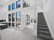 Open-concept foyer featuring tile floors, large windows and stairway at 800 S Blvd Of The Presidents # 19, Sarasota, FL 34236
