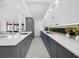 Stylish kitchen with gray and white cabinets, long island, modern fixtures and lots of storage at 800 S Blvd Of The Presidents # 19, Sarasota, FL 34236