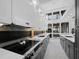 Contemporary kitchen featuring stainless steel appliances, gray cabinets, and stylish backsplash with great light at 800 S Blvd Of The Presidents # 19, Sarasota, FL 34236