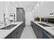 Galley style kitchen with stainless appliances, gray and white cabinets, and modern backsplash at 800 S Blvd Of The Presidents # 19, Sarasota, FL 34236