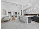 Bright, open-concept living room with modern furnishings, island seating, and light, neutral decor at 800 S Blvd Of The Presidents # 19, Sarasota, FL 34236