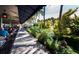 Outdoor seating area surrounded by lush tropical plants, perfect for enjoying the beautiful Florida weather at 800 S Blvd Of The Presidents # 19, Sarasota, FL 34236