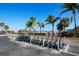 Organized scooter parking area near residential buildings, providing convenient transportation with palm tree views at 800 S Blvd Of The Presidents # 19, Sarasota, FL 34236