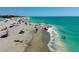 Aerial view of the beach featuring clear water, beautiful sand, and plenty of people enjoying the day at 807 Mohawk Rd, Venice, FL 34293