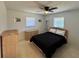 Bright bedroom featuring carpet floors, ceiling fan, a natural wood bed frame, and natural colored wood furniture at 807 Mohawk Rd, Venice, FL 34293