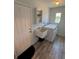 Laundry room featuring a utility sink, washer, dryer, wood look vinyl flooring, and a storage shelf at 807 Mohawk Rd, Venice, FL 34293