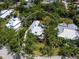 Aerial view of property showcasing the house, pool, lush landscaping, and surrounding neighborhood at 8871 Fishermens Bay Dr, Sarasota, FL 34231