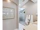A bathroom featuring a walk-in shower with glass doors, and a neutral toned vanity area at 8871 Fishermens Bay Dr, Sarasota, FL 34231