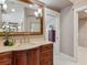Updated bathroom featuring a large mirror over the sink and an open doorway to the bedroom at 8871 Fishermens Bay Dr, Sarasota, FL 34231