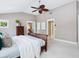 Large bedroom with a ceiling fan, a cozy color palette, lots of windows, and bright, neutral carpet at 8871 Fishermens Bay Dr, Sarasota, FL 34231