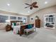 Spacious bedroom features a vaulted ceiling, neutral color palette, and a carved wood fan at 8871 Fishermens Bay Dr, Sarasota, FL 34231