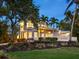 Beautiful two-story home with lush landscaping, a charming balcony, and a welcoming front entrance at 8871 Fishermens Bay Dr, Sarasota, FL 34231