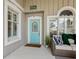 Charming entryway featuring a light blue front door with decorative details and a welcoming atmosphere at 8871 Fishermens Bay Dr, Sarasota, FL 34231