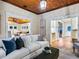 Inviting living room showcasing an open floor plan, white walls, wood ceilings, and stylish furniture at 8871 Fishermens Bay Dr, Sarasota, FL 34231
