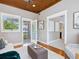 Neutral room with tongue and groove ceiling, hardwood flooring, and access to a deck at 8871 Fishermens Bay Dr, Sarasota, FL 34231