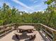 Charming outdoor picnic area surrounded by lush trees, perfect for enjoying nature and dining at 8871 Fishermens Bay Dr, Sarasota, FL 34231