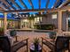 Private backyard retreat featuring a pool, brick patio, and an outdoor seating area under a wooden pergola at 8871 Fishermens Bay Dr, Sarasota, FL 34231
