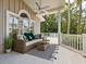 Cozy outdoor seating area on a covered porch with comfortable furniture and scenic views at 8871 Fishermens Bay Dr, Sarasota, FL 34231
