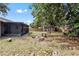 View of the backyard with a screened patio and a small storage shed at 920 36Th W St, Bradenton, FL 34205