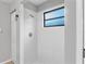 Bathroom featuring a tiled shower with shower head and an adjacent window at 920 36Th W St, Bradenton, FL 34205