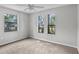 Cozy bedroom featuring plush carpeting, three windows, and neutral paint, creating a serene atmosphere at 920 36Th W St, Bradenton, FL 34205