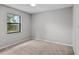 Carpeted bedroom with a large window providing natural light and a peaceful view at 920 36Th W St, Bradenton, FL 34205