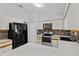 Functional kitchen with white countertops, cabinetry, black appliances, and backsplash tile detail at 920 36Th W St, Bradenton, FL 34205