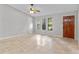Bright living room featuring tile floors, neutral paint, a wood front door, and multiple windows at 920 36Th W St, Bradenton, FL 34205