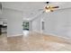 Spacious living area featuring tile flooring, vaulted ceiling, and access to the kitchen and backyard at 920 36Th W St, Bradenton, FL 34205