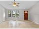 Inviting living room with tile flooring, a ceiling fan, and large windows that let in natural light at 920 36Th W St, Bradenton, FL 34205