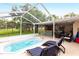 Expansive backyard showcasing a pool, outdoor kitchen, and entertaining spaces at 104 Shoreland Dr, Osprey, FL 34229