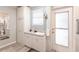 Well-lit bathroom with ample storage, updated fixtures, and a convenient door to the outdoor space at 104 Shoreland Dr, Osprey, FL 34229