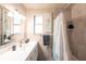 A well-lit bathroom featuring a vanity, mirror, and shower with curtain at 104 Shoreland Dr, Osprey, FL 34229