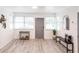 Inviting entryway with light wood-look floors, lots of natural light, decorative mirror and accent table at 104 Shoreland Dr, Osprey, FL 34229