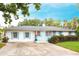 Charming single-story home featuring light blue shutters, a well-manicured lawn, and a concrete driveway at 104 Shoreland Dr, Osprey, FL 34229